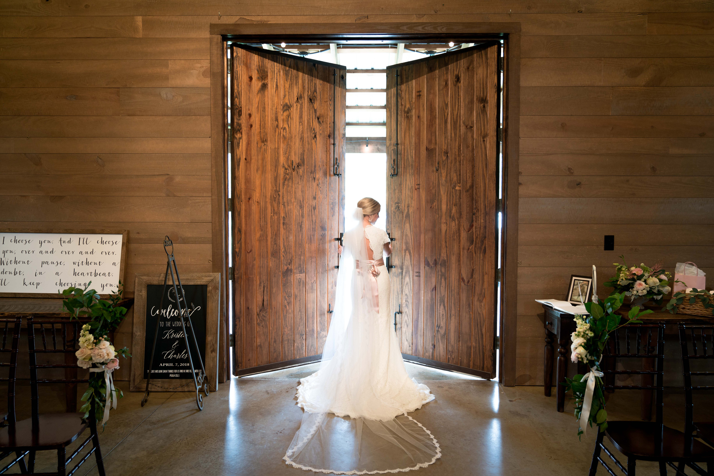 A bride standing in front of an open door.