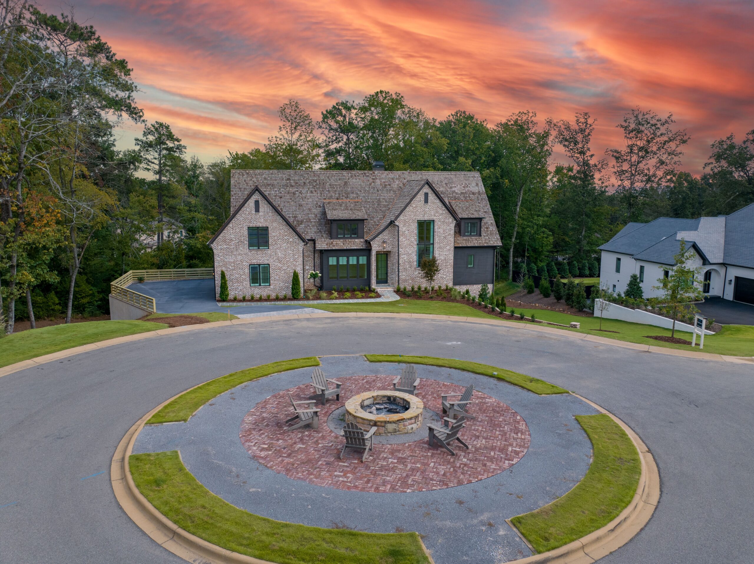 A circular driveway with fire pit in the center.