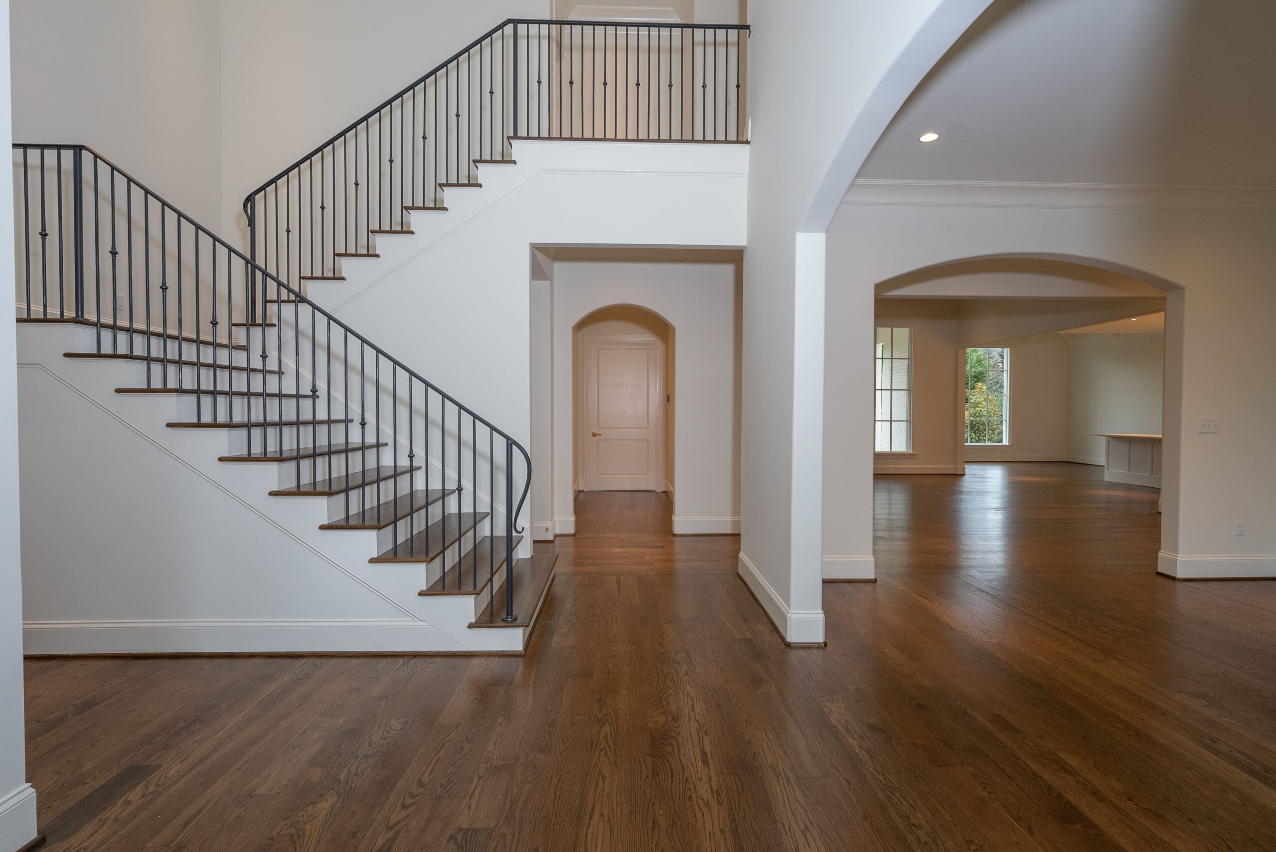 A large open floor plan with stairs leading to the second story.