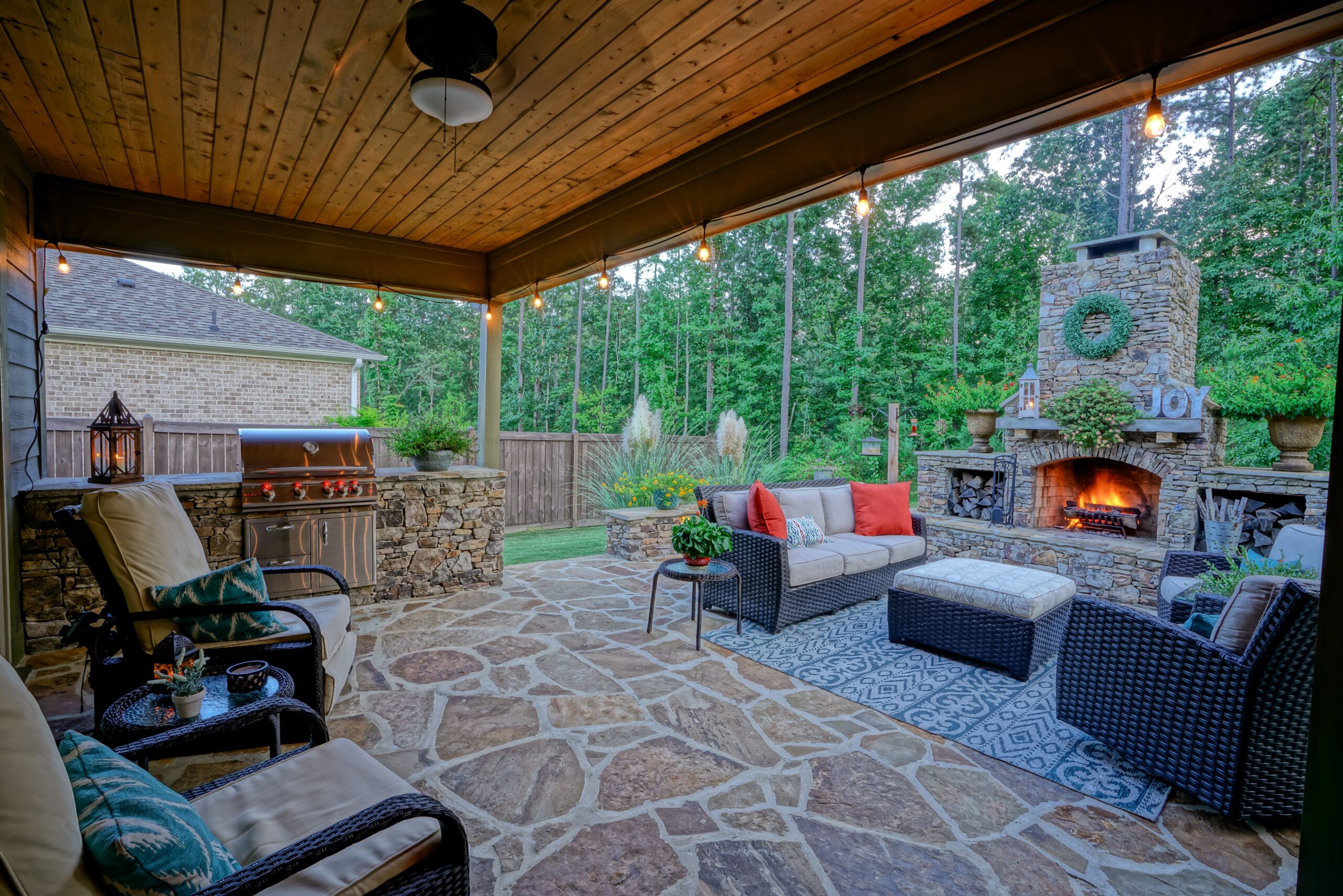 A patio with furniture and a fire place.