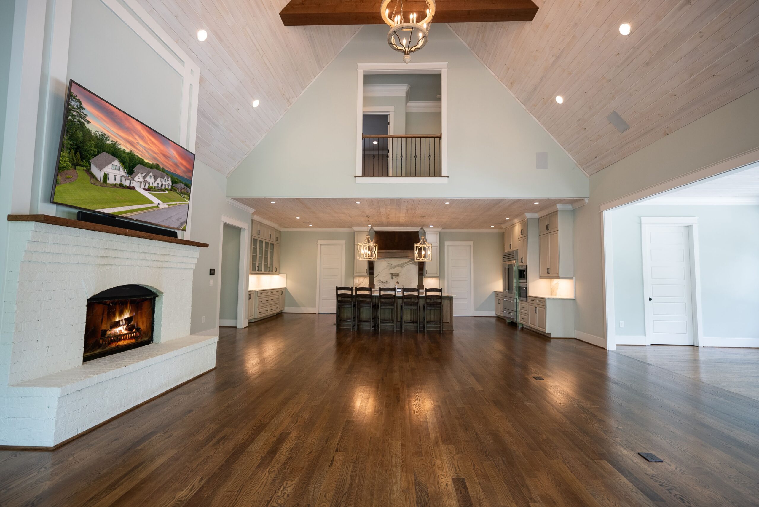 A large open room with wood floors and a fireplace.